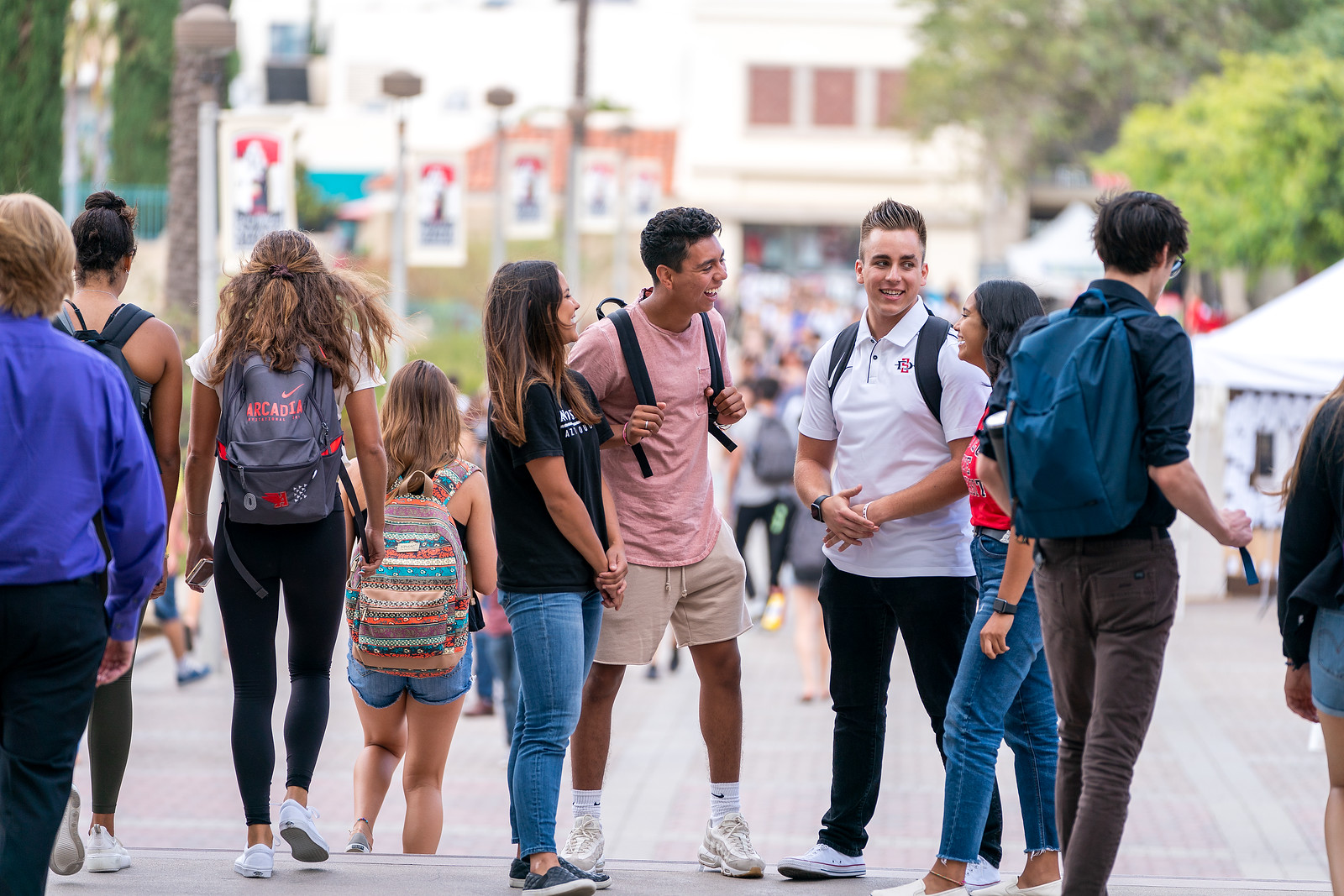 Students standing on walkway while chatting